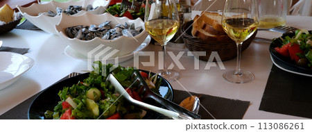 People fine dining seafood and white wine on the table . High quality photo People fine dining seafood and white wine on the table . High quality photo 113086261