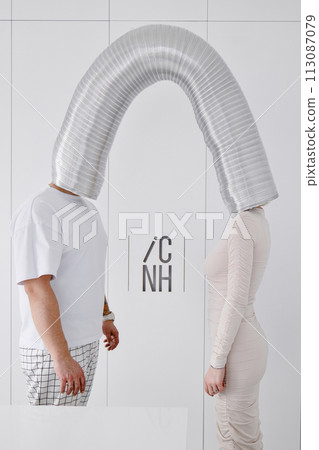 A man and a woman standing next to each other against a wall A man and a woman standing next to each other against a wall 113087079