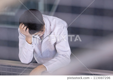 Men in work clothes, middle-aged, embarrassed 113087206