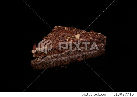 Triangular cake with chocolate sprinkle on a dark background 113087719