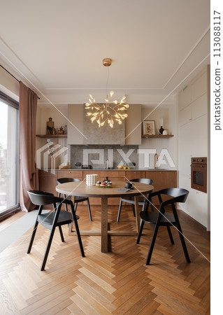 Interior design with round table, chairs, chandelier in dining room 113088117