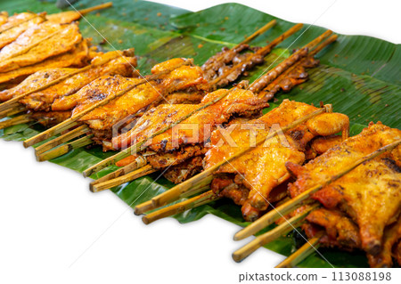 Top view of Grilled chicken on banana leaves, focus selective Top view of Grilled chicken on banana leaves, focus selective 113088198