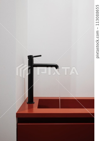 Red countertop with black faucet on a bathroom sink Red countertop with black faucet on a bathroom sink 113088655