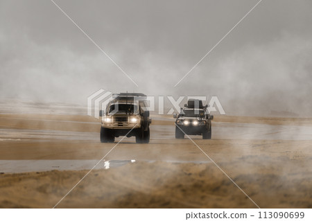 Two 4x4 cars driving along the foggy beach in search of adventure. Fraser Island, Queensland, Australia Two 4x4 cars driving along the foggy beach in search of adventure. Fraser Island, Queensland, Australia 113090699