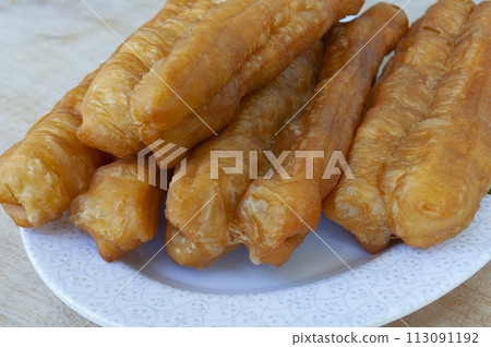 Close up of cakoi or youtiao cake on white plate. Asian food concept 113091192
