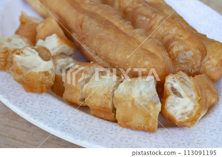 Close up of cut cakoi or Youtiao on white plate. Asian food concept 113091195