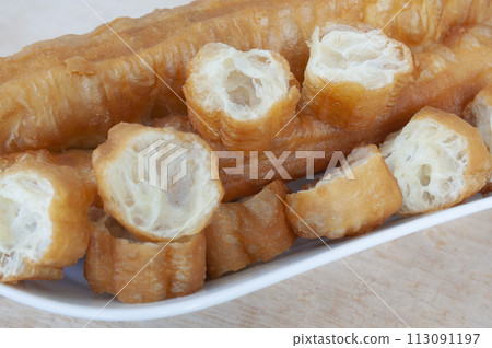 Close up of cut cakoi or youtiao cake on white plate. Asian food concept 113091197