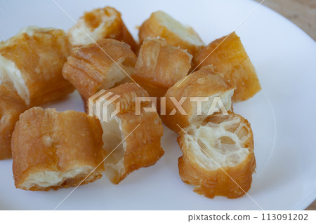 Close up view of cut cakoi or youtiao cake on white plate. Asian food concept. 113091202