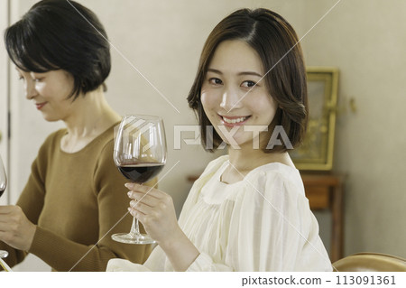 young woman holding wine in hand 113091361