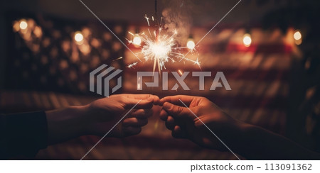 Two hands holding sequins with warm glowing lights on the background of the American flag. 113091362
