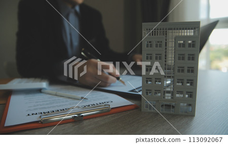 Real estate agent and customer signing contract to buy house, insurance or loan real estate.rent a house,get insurance or loan real estate or property. Real estate agent and customer signing contract to buy house, insurance or loan real estate.rent a house,get insurance or loan real estate or property. 113092067