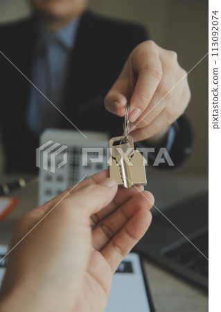 Real estate agent and customer signing contract to buy house, insurance or loan real estate.rent a house,get insurance or loan real estate or property. 113092074