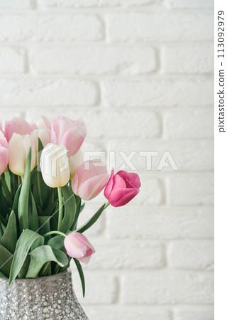 Bouquet of pink and white tulips in vase 113092979