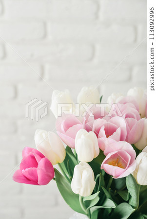 Bouquet of pink and white tulips in vase 113092996