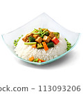 A flavorful and aromatic stir-fry in a square glass dish, garnished with sliced scallions 113093206