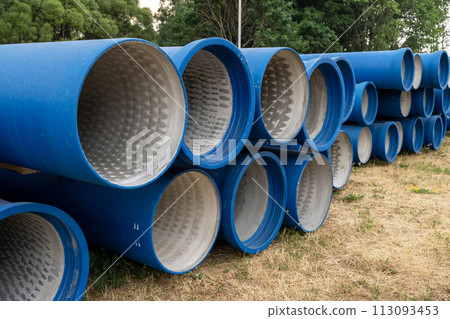 Concrete pipes covered with blue waterproofing at construction site 113093453