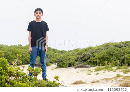 boy standing on the beach boy standing on the beach 113093712