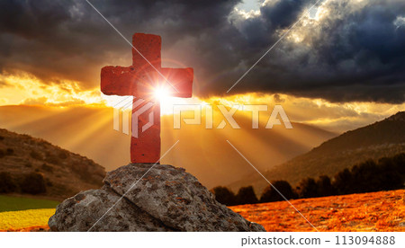 Old Stone Religious Cross on a Dark Dramatic Cloudy Sky with Sun Rays - Generative Ai 113094888