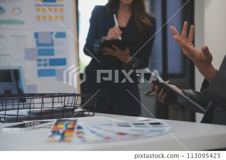 Close up ux developer and ui designer use augmented reality brainstorming about mobile app interface wireframe design on desk at modern office.Creative digital development agency 113095425
