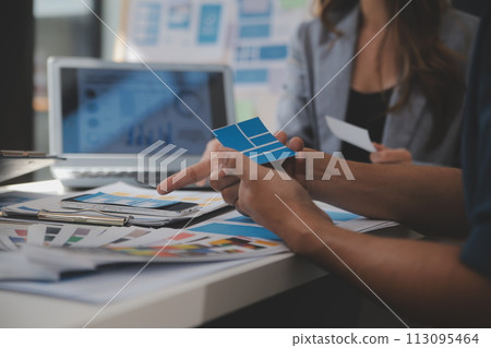 Close up ux developer and ui designer use augmented reality brainstorming about mobile app interface wireframe design on desk at modern office.Creative digital development agency 113095464
