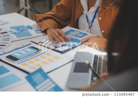 Close up ux developer and ui designer use augmented reality brainstorming about mobile app interface wireframe design on desk at modern office.Creative digital development agency 113095467