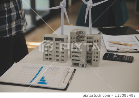 Electrical engineer with businessman discussing new project installation solar cell panel on the roof of building. Alternative energy concept. Electrical engineer with businessman discussing new project installation solar cell panel on the roof of building. Alternative energy concept. 113095492