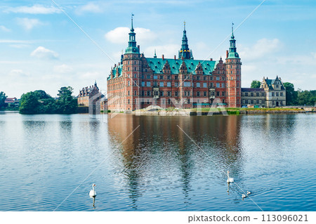 View of Frederiksborg castle with white swans on lake in Hillerod, Denmark 113096021