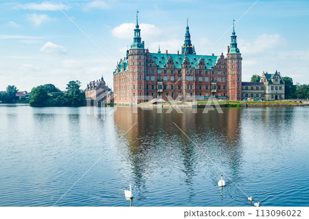 View of Frederiksborg castle with white swans on lake in Hillerod, Denmark 113096022