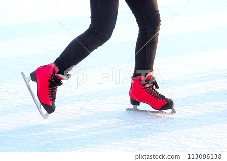 legs of a skater on an ice rink. hobbies and winter sports 113096138