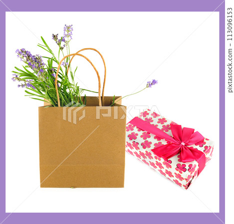 Gift in bright packaging and paper bag with flowers isolated on a white. Gift in bright packaging and paper bag with flowers isolated on a white. 113096153