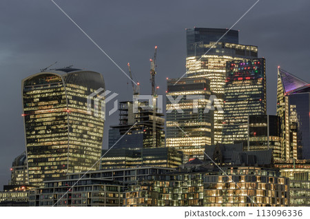 The illuminated of skyscraper in the business district of London just after sunset. The illuminated of skyscraper in the business district of London just after sunset. 113096336