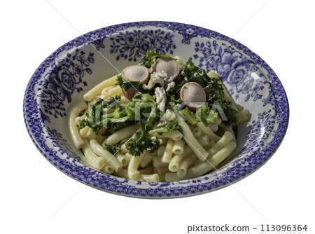 Plate of Penne pasta with Sausage, Pork and Kale isolated on white background with clipping path. 113096364