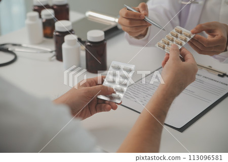 Healthcare service and pharmacy worker with customer at store counter for medication explanation. Pharmaceutical advice and opinion of pharmacist helping girl with medicine information. Healthcare service and pharmacy worker with customer at store counter for medication explanation. Pharmaceutical advice and opinion of pharmacist helping girl with medicine information. 113096581