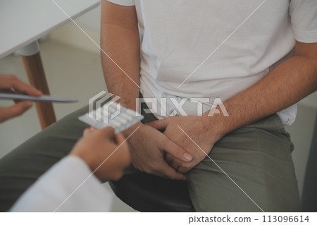 Male diseases. Man presses hands to his groin and suffering from pain, panorama, cropped, studio shot 113096614