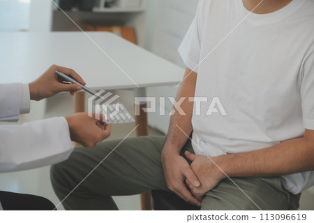 Male diseases. Man presses hands to his groin and suffering from pain, panorama, cropped, studio shot 113096619