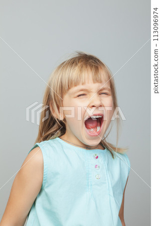Screaming young girl against grey background Screaming young girl against grey background 113096974