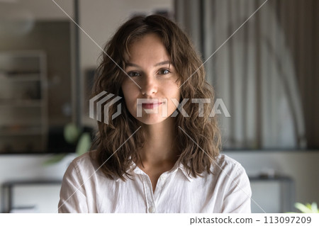 Positive business professional woman with wavy hair looking at camera Positive business professional woman with wavy hair looking at camera 113097209