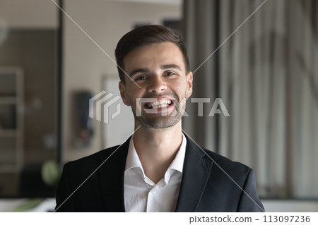 Cheerful handsome business man in formal jacket looking at camera Cheerful handsome business man in formal jacket looking at camera 113097236