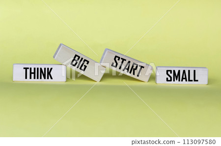 Conceptual words Think Big, Start Small on wooden blocks on a beautiful background.  113097580