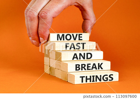 Move fast and break things symbol. Concept words Move fast and break things on wooden blocks. Beautiful orange background. Businessman hand. Business, move fast and break things concept. Copy space. Move fast and break things symbol. Concept words Move fast and break things on wooden blocks. Beautiful orange background. Businessman hand. Business, move fast and break things concept. Copy space. 113097600