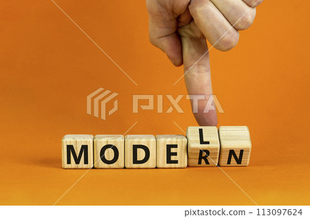 Modern model symbol. Businessman turns wooden cubes and changes the word 'model' to 'modern'. Beautiful orange table, orange background, copy space. Business and modern model concept. Modern model symbol. Businessman turns wooden cubes and changes the word 'model' to 'modern'. Beautiful orange table, orange background, copy space. Business and modern model concept. 113097624