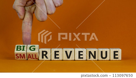 Symbol for a better revenue. Male hand turns wooden cubes and changes words 'small revenue' to 'big revenue'. Beautiful orange background. Copy space. Business and big revenue concept. Symbol for a better revenue. Male hand turns wooden cubes and changes words 'small revenue' to 'big revenue'. Beautiful orange background. Copy space. Business and big revenue concept. 113097650
