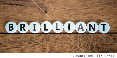 Brilliant symbol. The concept word Brilliant on white circles. Beautiful wooden table, wooden background. Business and brilliant concept. Copy space. Brilliant symbol. The concept word Brilliant on white circles. Beautiful wooden table, wooden background. Business and brilliant concept. Copy space. 113097654