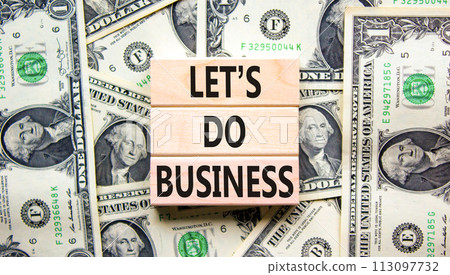 let is do business symbol. Concept words let is do business on beautiful wooden blocks. Dollar bills. Beautiful dollar bills background. let is do business concept. Copy space. 113097732