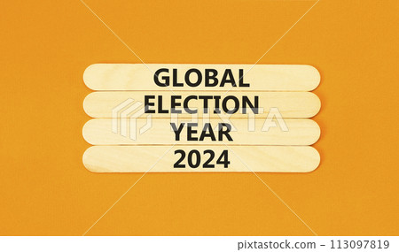 Global election year 2024 symbol. Concept words Global election year 2024 on wooden stick. Beautiful orange table orange background. Business Global election year 2024 concept. Copy space. Global election year 2024 symbol. Concept words Global election year 2024 on wooden stick. Beautiful orange table orange background. Business Global election year 2024 concept. Copy space. 113097819