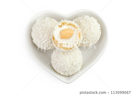 round candy raffaello with coconut flakes and nut in ceramic bowl isolated on white background. Top view. Flat lay. 113099087