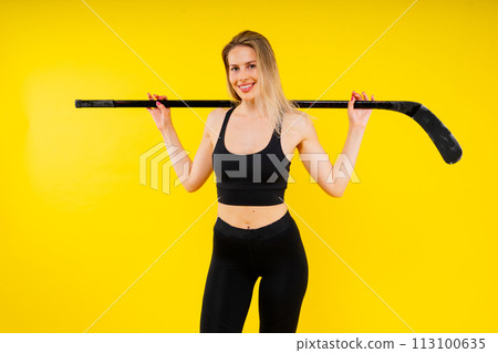 Luxuriously dressed female with a hockey stick. Women's winter sports. Luxuriously dressed female with a hockey stick. Women's winter sports. 113100635