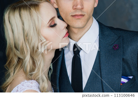 Cute wedding couple in interior of classic studio. They kiss and hug each other. Cute wedding couple in interior of classic studio. They kiss and hug each other. 113100646