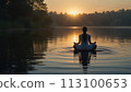 Woman meditating in the orange sunset 113100653