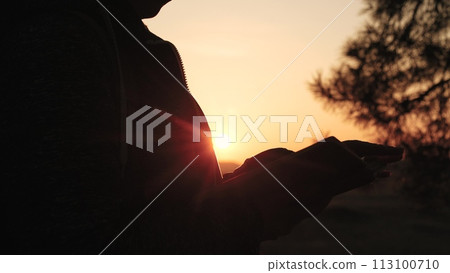 girl woman praying at sunset, hand sunset faith pain, asking heaven for help, bible book, tranquil sunset praying, young woman spirituality, divine connection sunset, spiritual growth dusk 113100710